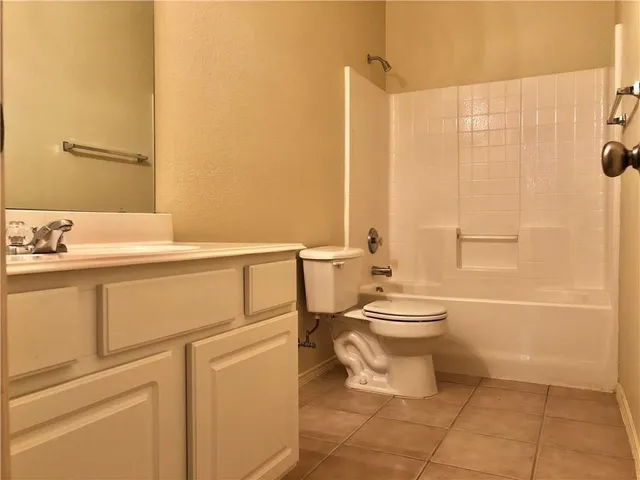 a open kitchen with stainless steel appliances granite countertop a stove and a refrigerator