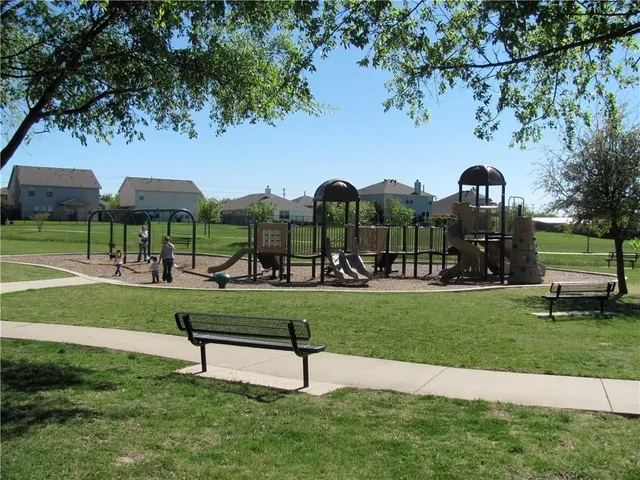 a view of a house with swimming pool and sitting area