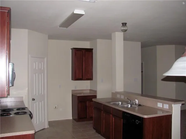 a view of an empty room with a fireplace