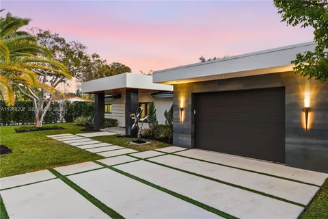 a view of a house with yard and furniture