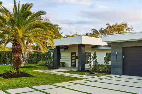 a view of a house with swimming pool and sitting area