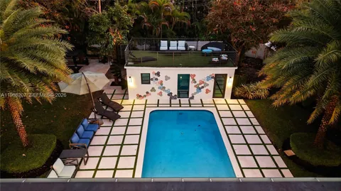 a spacious bedroom with a large bed and a potted plant