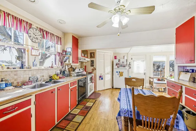 a kitchen with stainless steel appliances a stove a sink dishwasher and cabinets with wooden floor