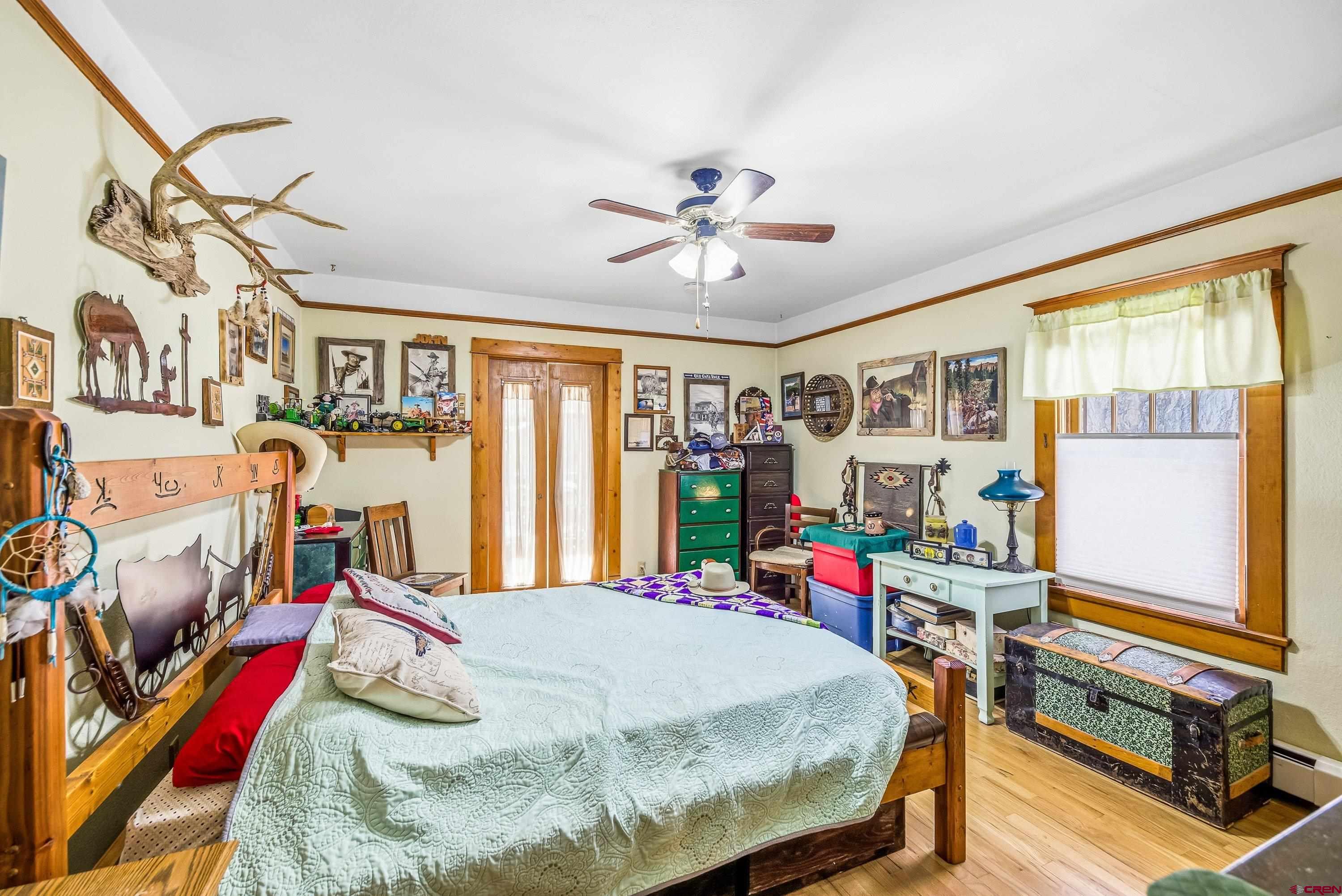 21568 Austin Road Austin, CO 81410 - Photo 15 of 37 a bed room with a bed and a chandelier