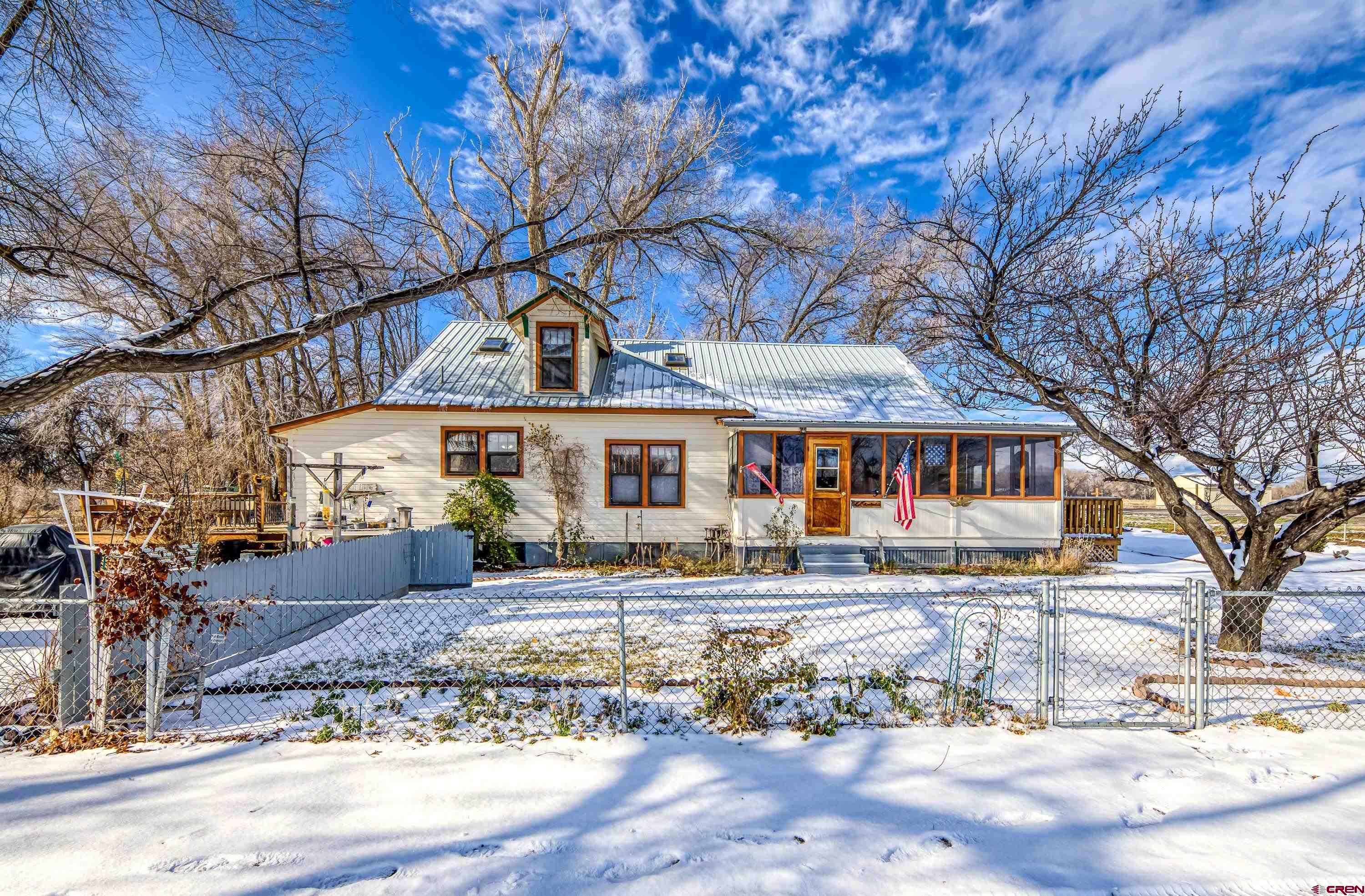 21568 Austin Road Austin, CO 81410 - Photo 2 of 37 a front view of a house with large trees