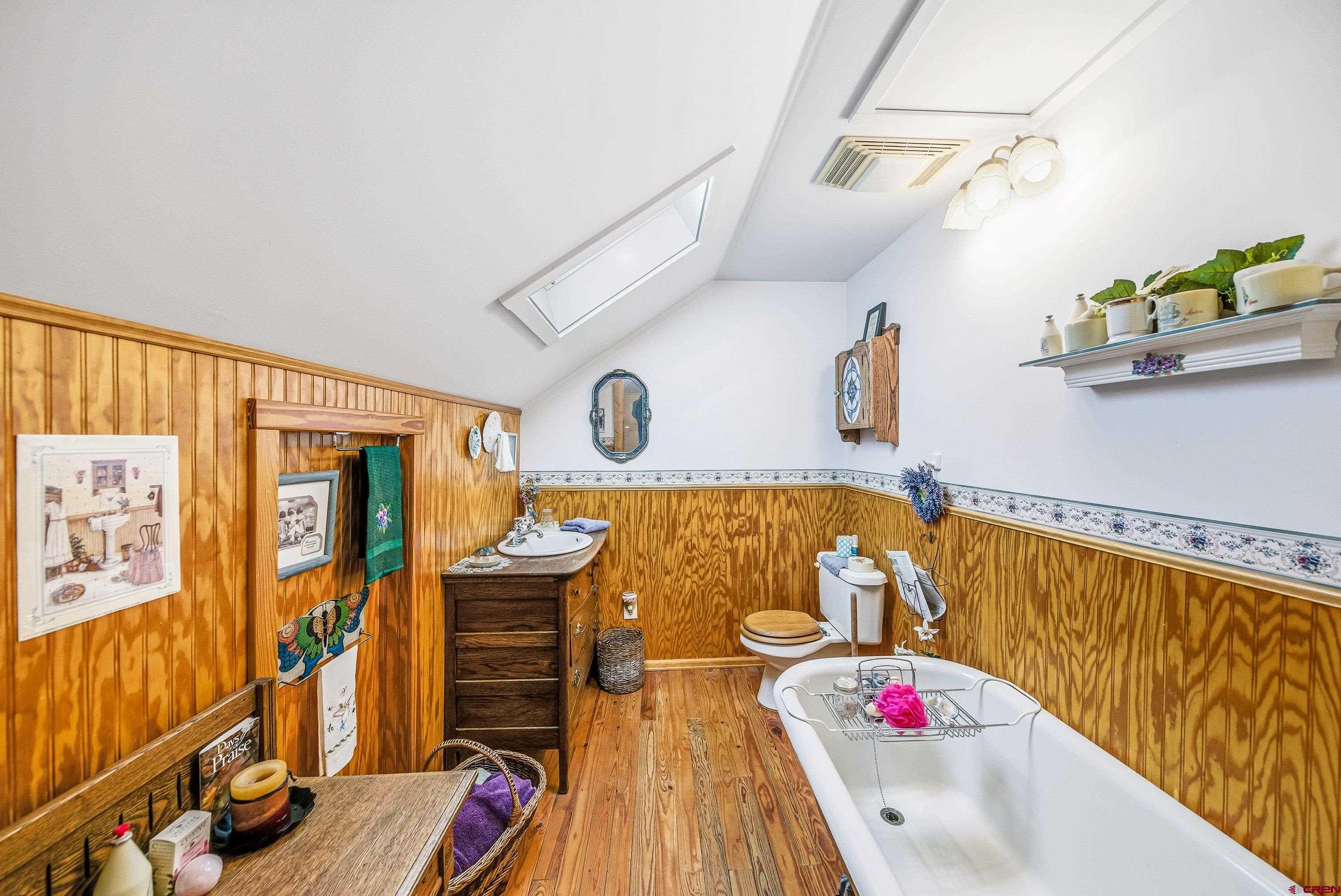 21568 Austin Road Austin, CO 81410 - Photo 24 of 37 a bedroom with furniture and a wooden floor