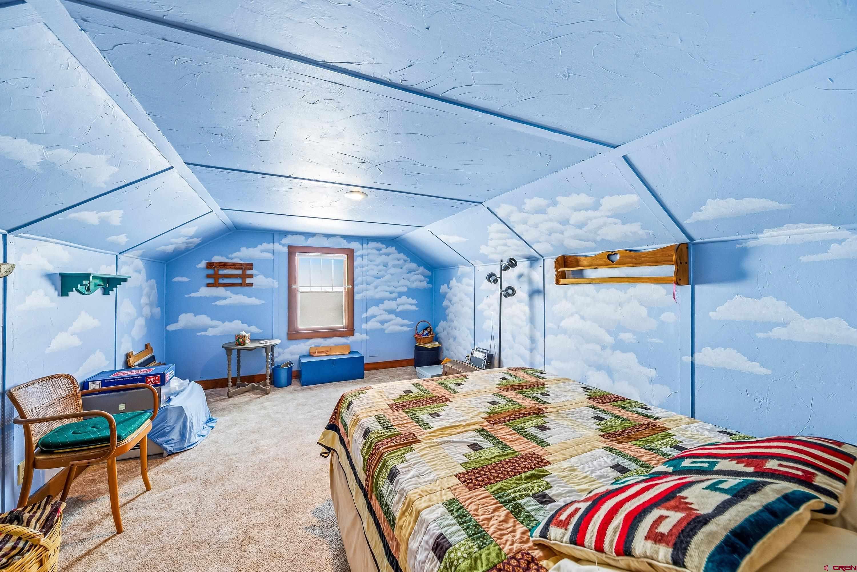 21568 Austin Road Austin, CO 81410 - Photo 25 of 37 a bedroom with a bed a chair and potted plant