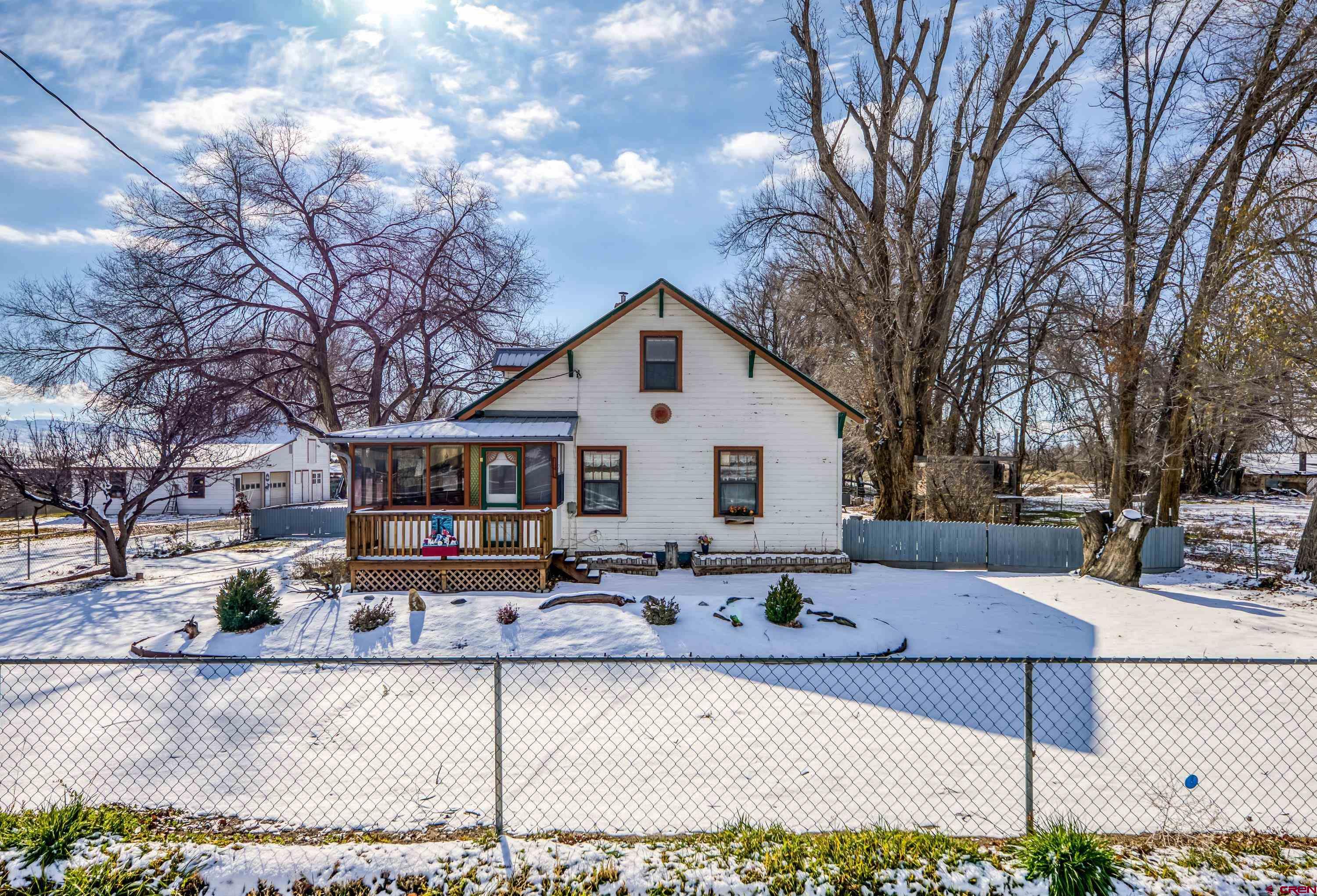 21568 Austin Road Austin, CO 81410 - Photo 3 of 37 a front view of house with yard covered in snow