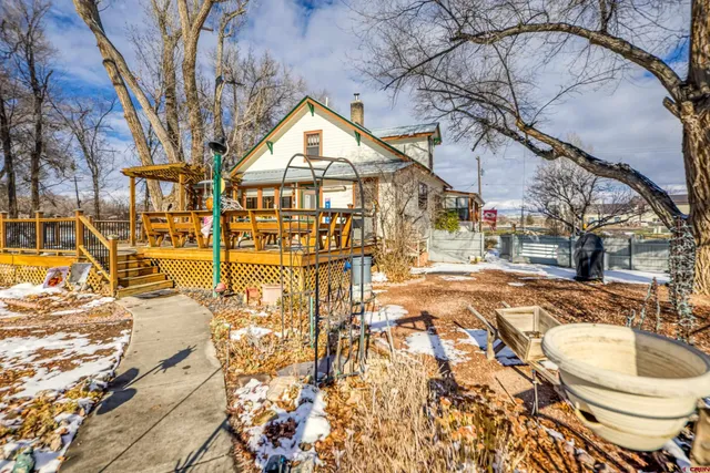 a view of a house with a yard covered in snow