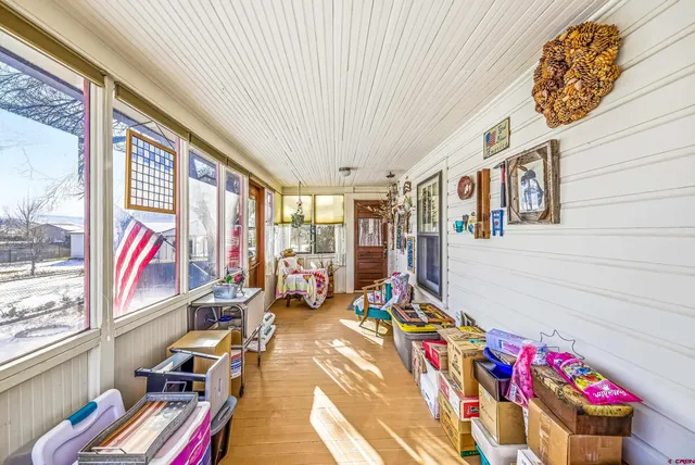 a very nice looking room with many windows and furniture