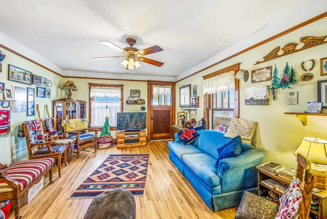 a living room with furniture fireplace and a large window