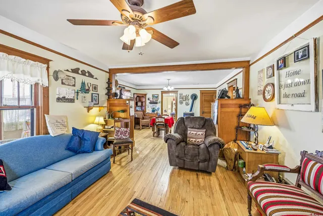 a living room with furniture and wooden floor