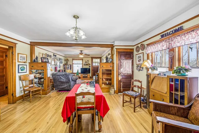 a large kitchen with stainless steel appliances granite countertop a stove a sink dishwasher and a dining table with bookshelf