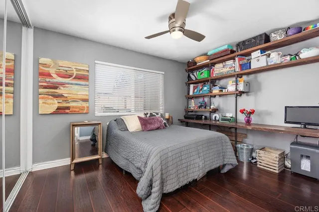 a bedroom with a bed a dresser and a book shelf