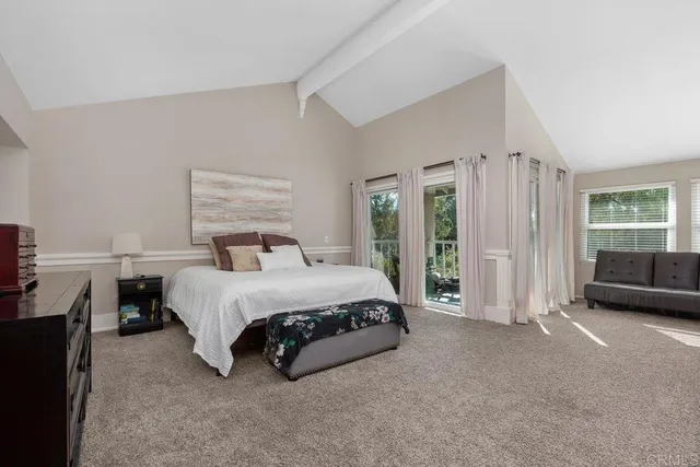 a spacious bedroom with a bed and a large window