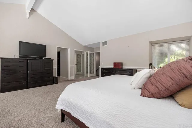 a bedroom with a bed and a television