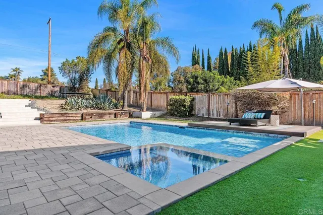 a view of a swimming pool with a patio