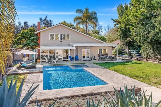 a view of a house with swimming pool and porch