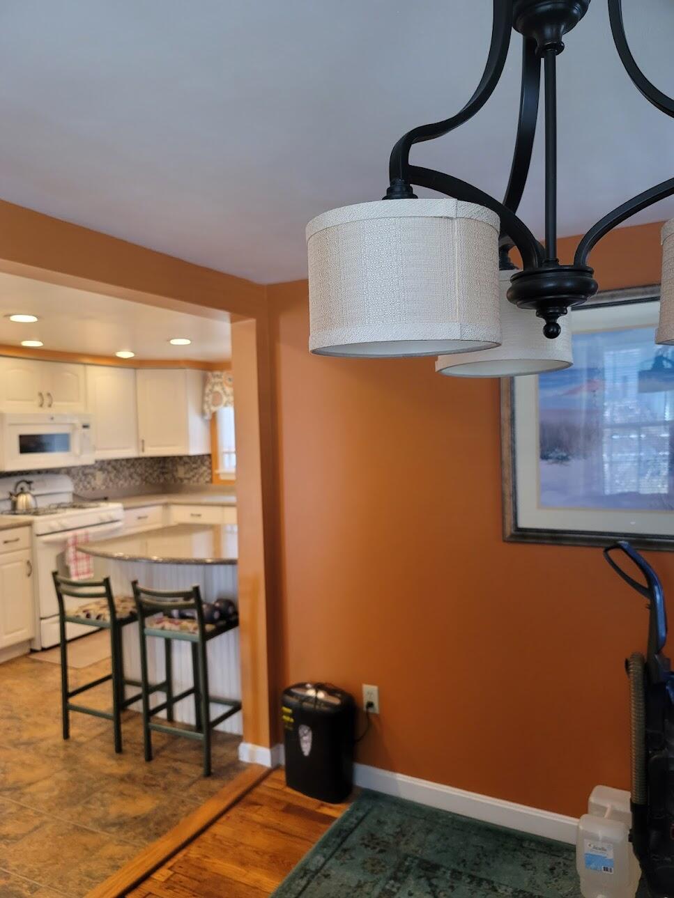 95 Spring Street Hyannis, MA 02601 - Photo 12 of 38 a kitchen with stainless steel appliances granite countertop a sink a stove top oven a dining table and chairs with wooden floor