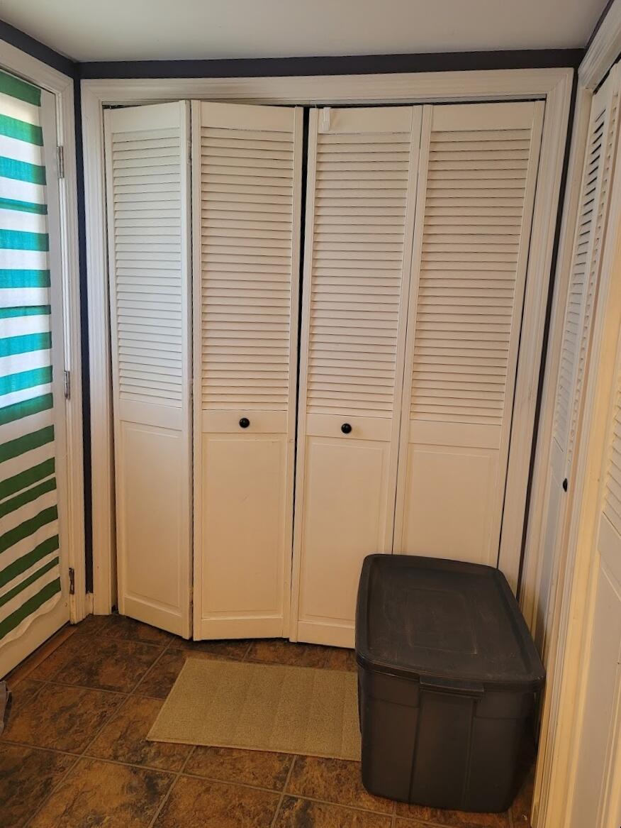 95 Spring Street Hyannis, MA 02601 - Photo 14 of 38 a living room with a chair and a potted plant