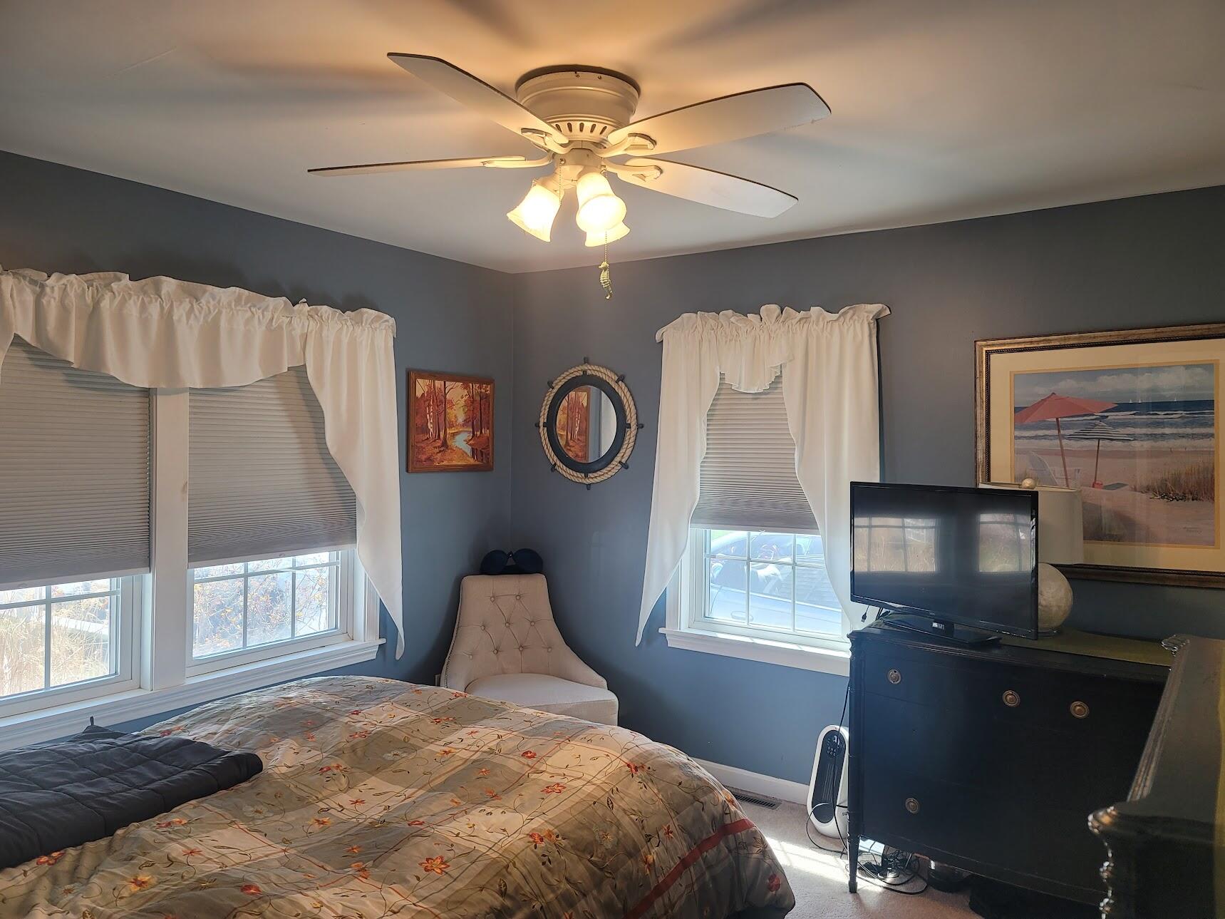 95 Spring Street Hyannis, MA 02601 - Photo 17 of 38 a bedroom with a bed and a flat tv screen on dresser