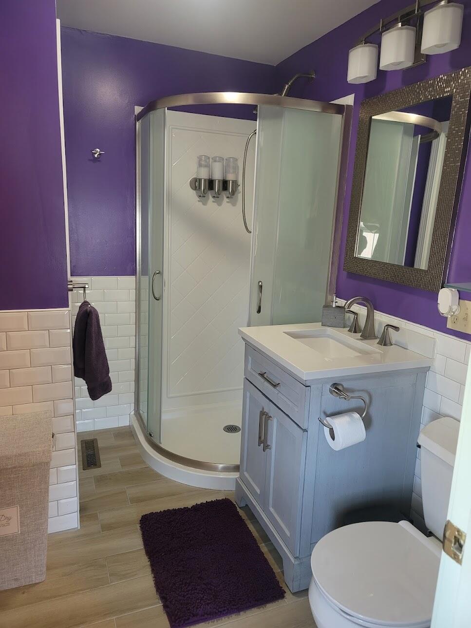 95 Spring Street Hyannis, MA 02601 - Photo 20 of 38 a bathroom with a sink a toilet a mirror and vanity