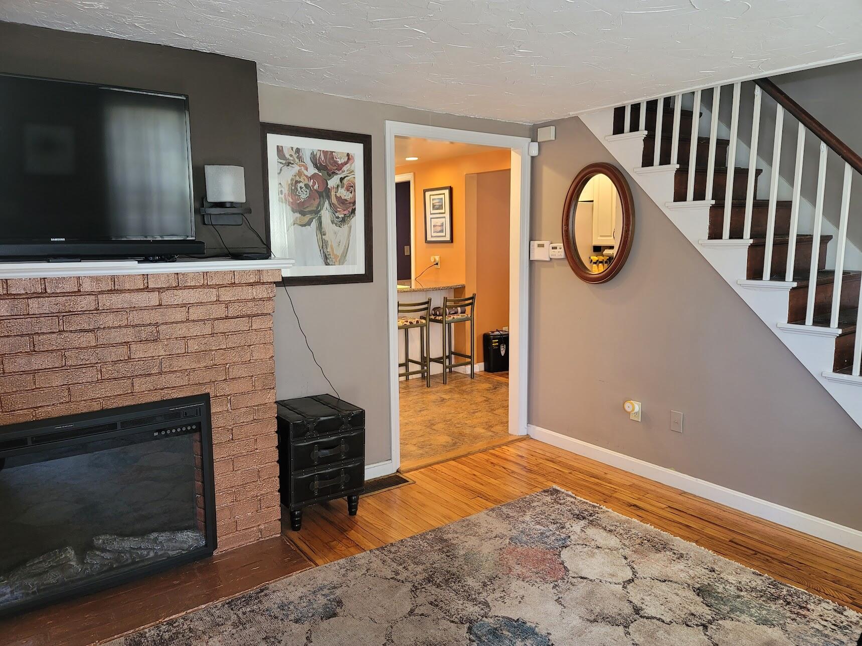 95 Spring Street Hyannis, MA 02601 - Photo 4 of 38 a living room with furniture and a fireplace
