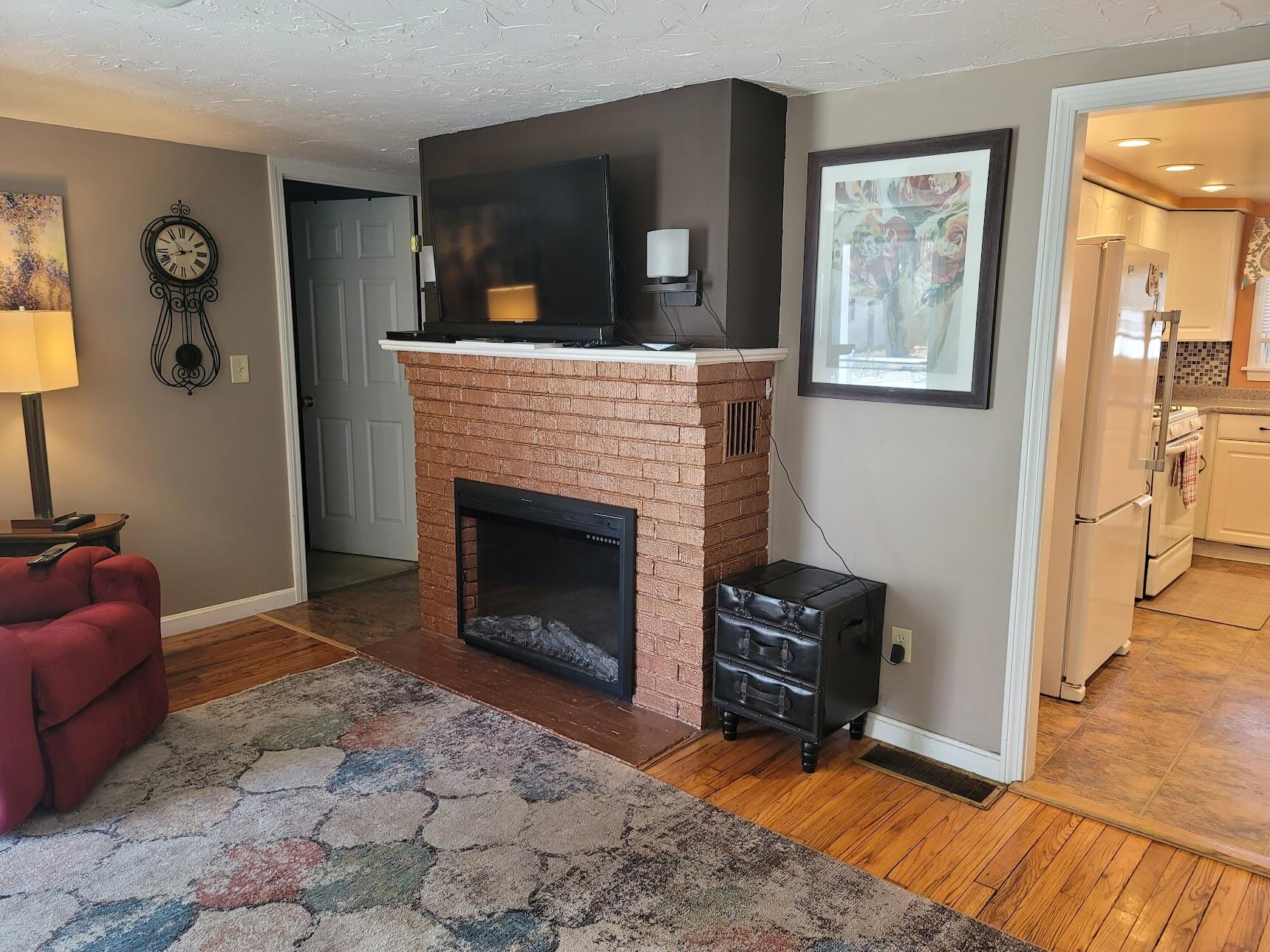 95 Spring Street Hyannis, MA 02601 - Photo 7 of 38 a living room with furniture and a fireplace