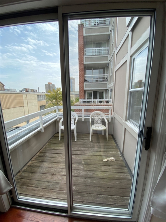 22 Chestnut Street, Unit 22 Cambridge, MA 02139 - Photo 11 of 18 a view of a living room and floor to ceiling window