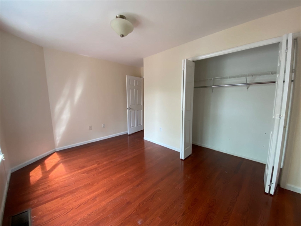 22 Chestnut Street, Unit 22 Cambridge, MA 02139 - Photo 15 of 18 a view of an empty room with wooden floor and a window
