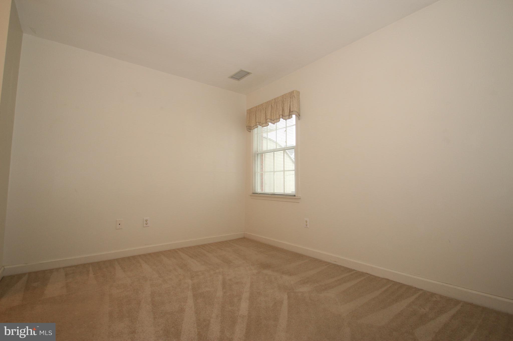 30 West Village Road Newark, DE 19713 - Photo 5 of 13 an empty room with a window