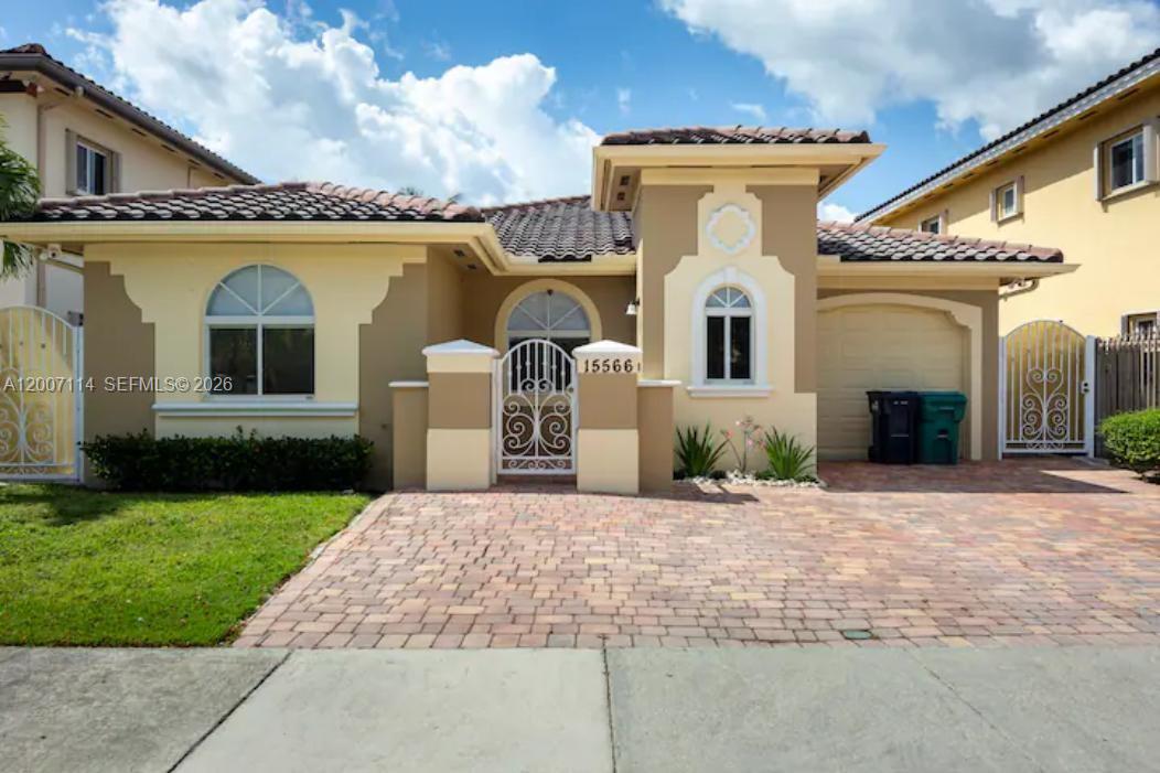 15566 Southwest 13th Terrace Miami, FL 33194 - Photo 1 of 27 a front view of a house with garden