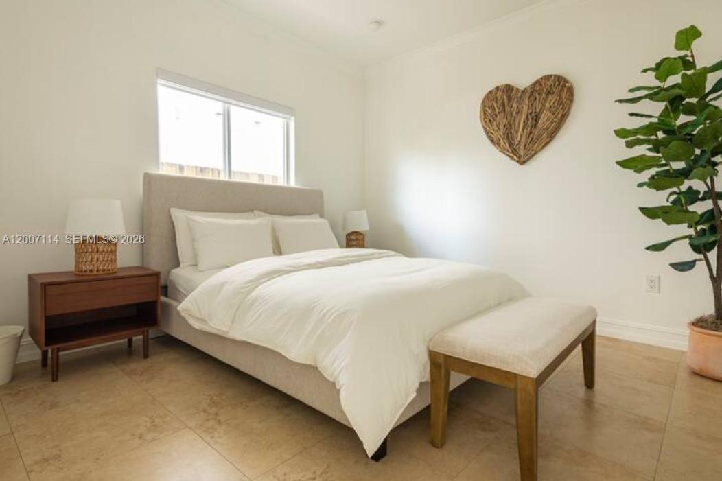 15566 Southwest 13th Terrace Miami, FL 33194 - Photo 14 of 27 a bedroom with a bed and a window