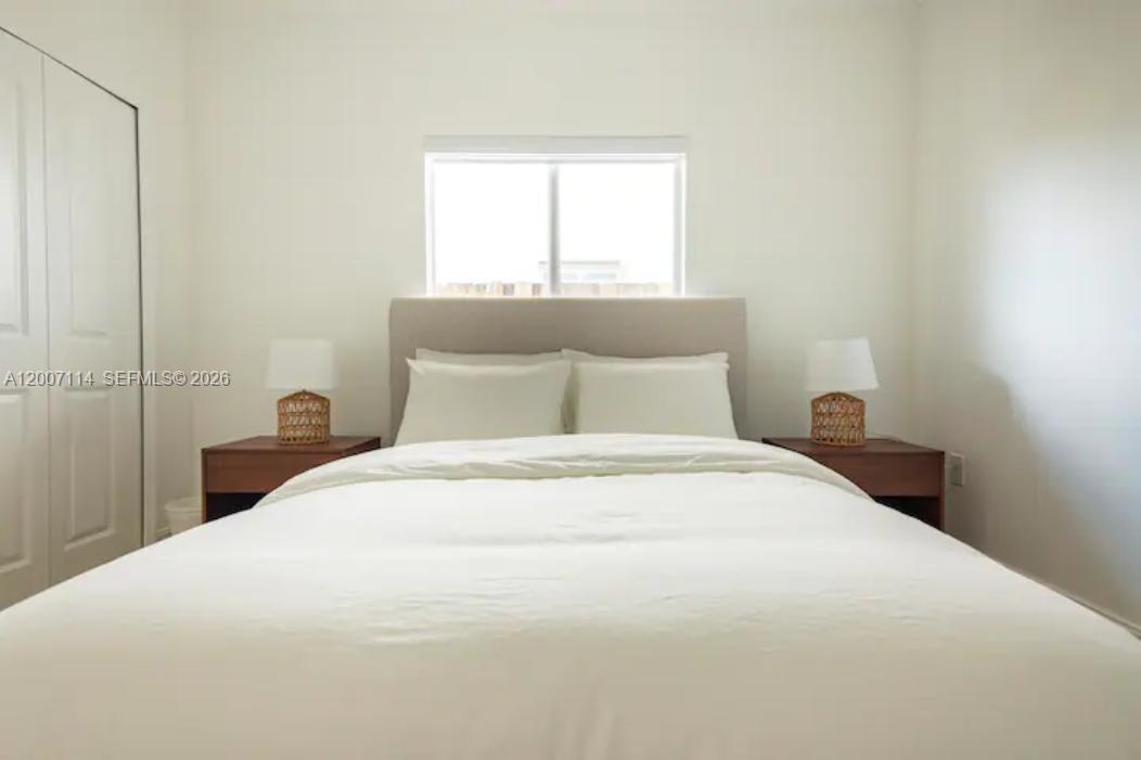 15566 Southwest 13th Terrace Miami, FL 33194 - Photo 15 of 27 a bedroom with a bed and window