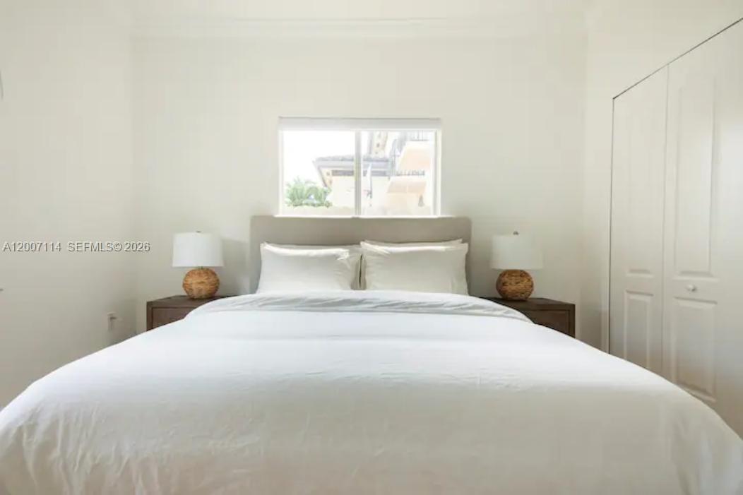 15566 Southwest 13th Terrace Miami, FL 33194 - Photo 17 of 27 a bedroom with a bed and window
