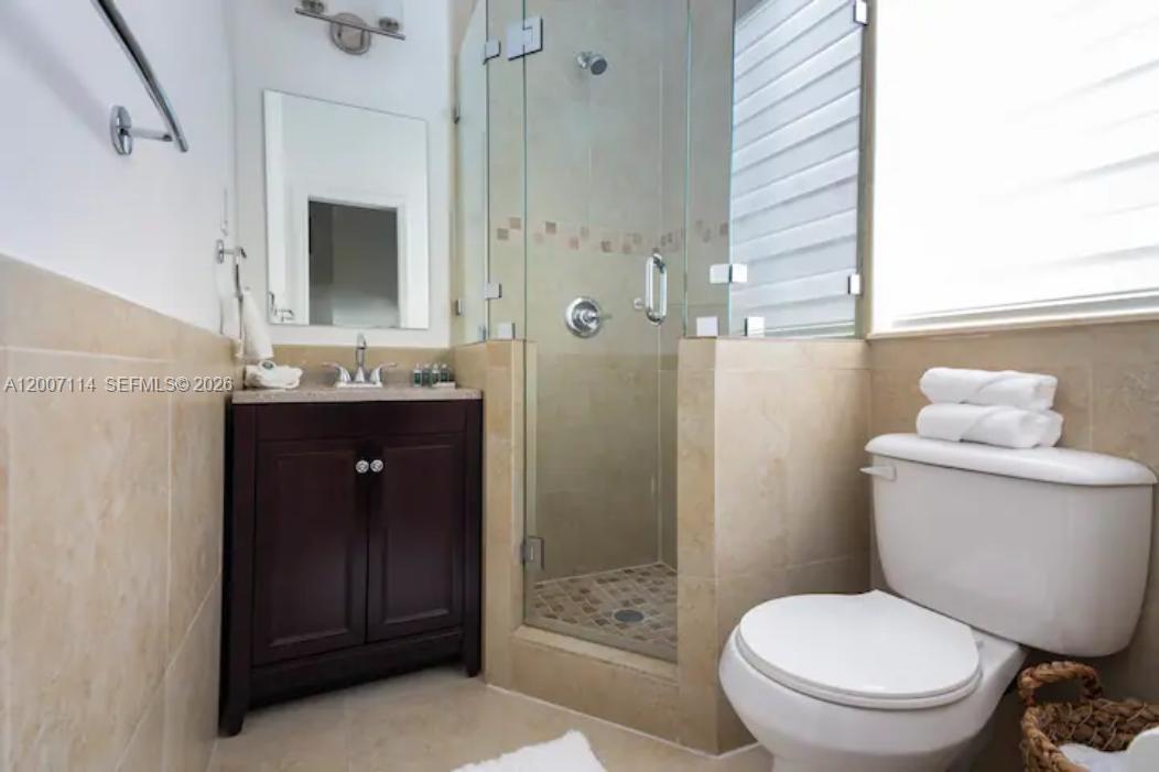 15566 Southwest 13th Terrace Miami, FL 33194 - Photo 20 of 27 a bathroom with a toilet a sink and shower