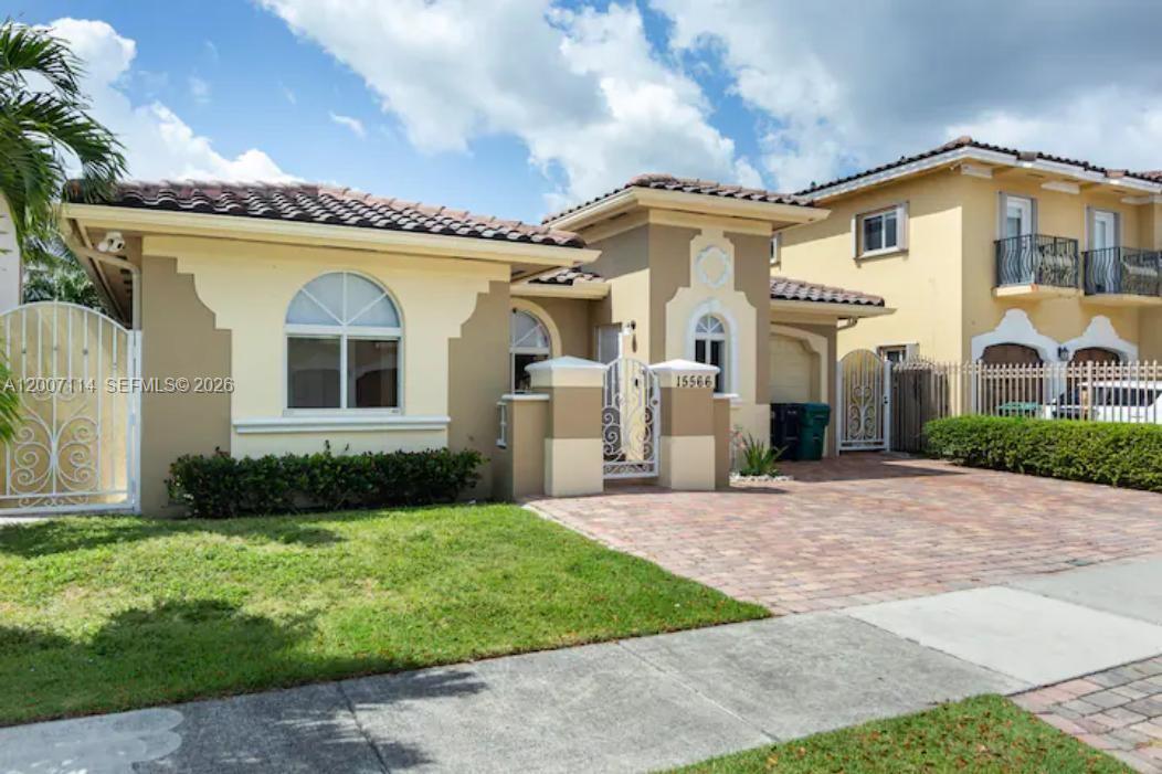 15566 Southwest 13th Terrace Miami, FL 33194 - Photo 2 of 27 a front view of a house with a garden
