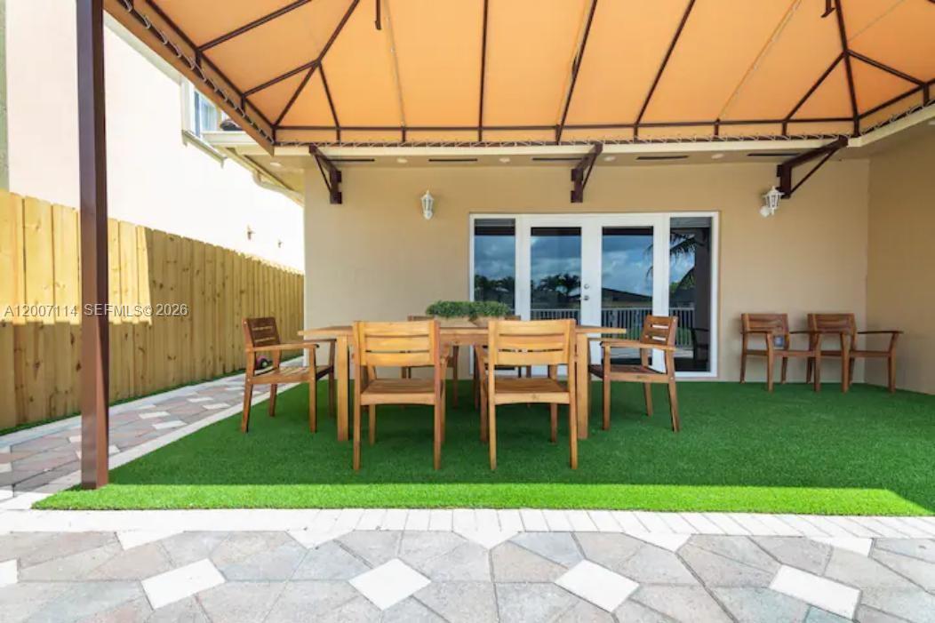 15566 Southwest 13th Terrace Miami, FL 33194 - Photo 24 of 27 a backyard of a house with glass table and chairs