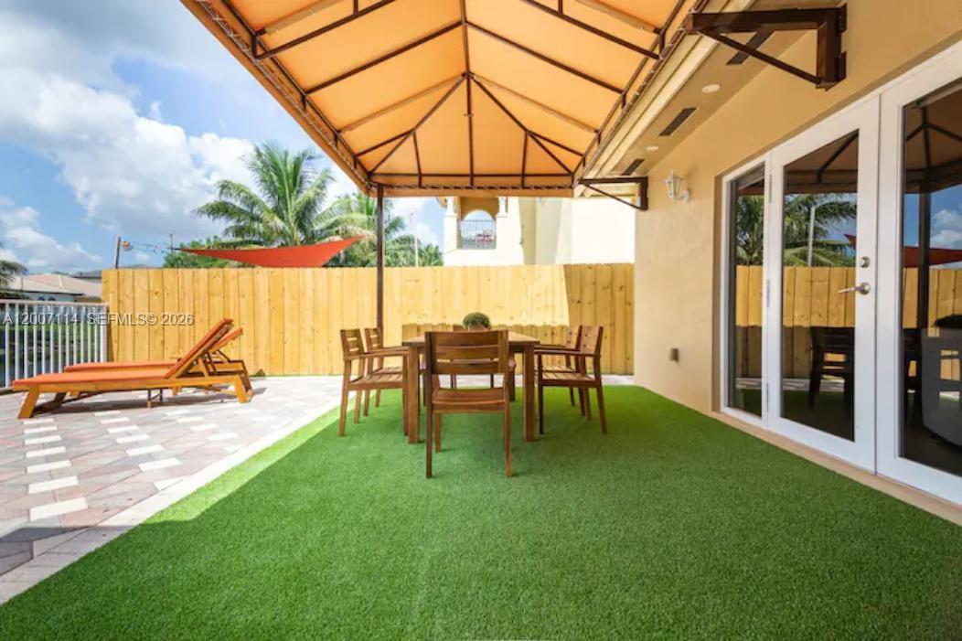 15566 Southwest 13th Terrace Miami, FL 33194 - Photo 25 of 27 a view of backyard with a table and chairs