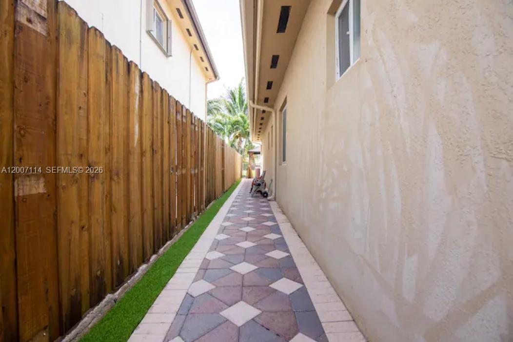 15566 Southwest 13th Terrace Miami, FL 33194 - Photo 27 of 27 a view of a pathway gate with wooden walls