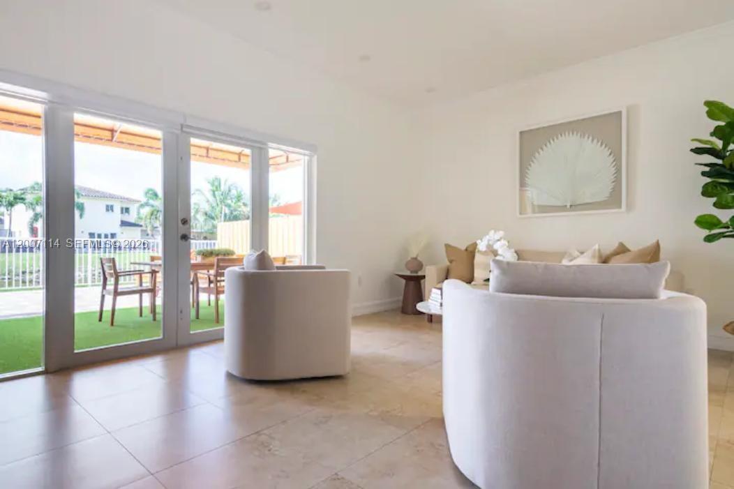 15566 Southwest 13th Terrace Miami, FL 33194 - Photo 5 of 27 a living room with furniture and a large window