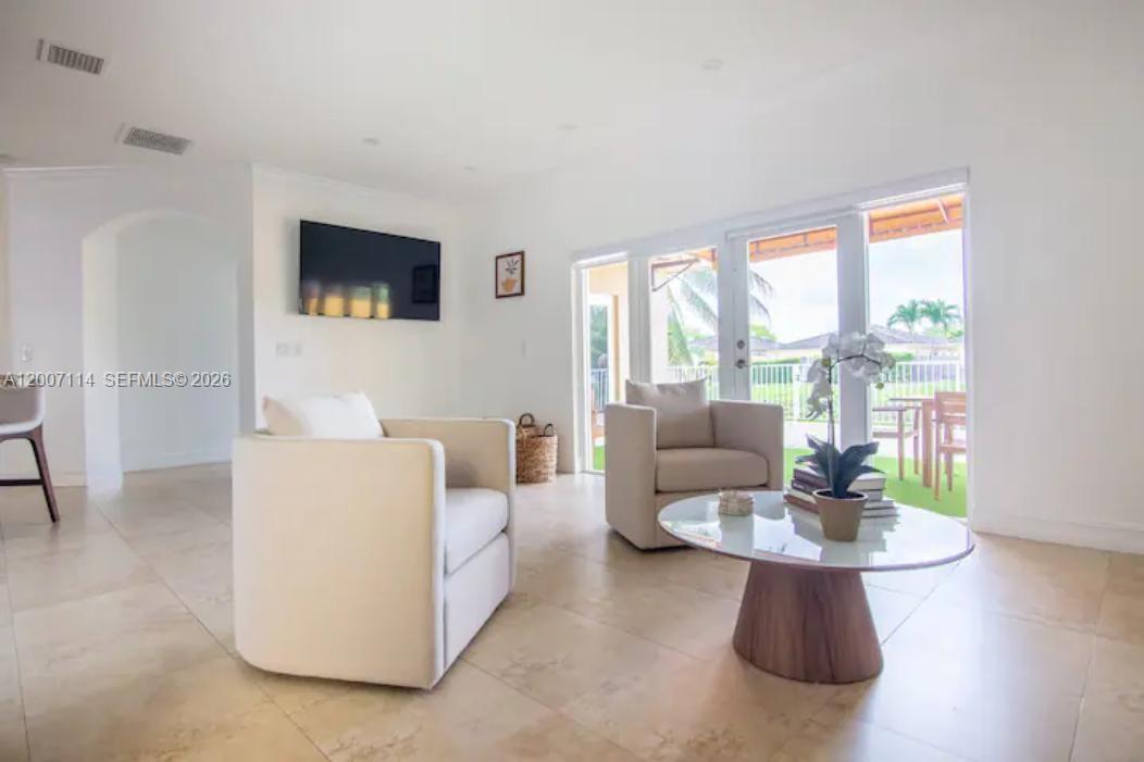 15566 Southwest 13th Terrace Miami, FL 33194 - Photo 7 of 27 a living room with furniture and a flat screen tv
