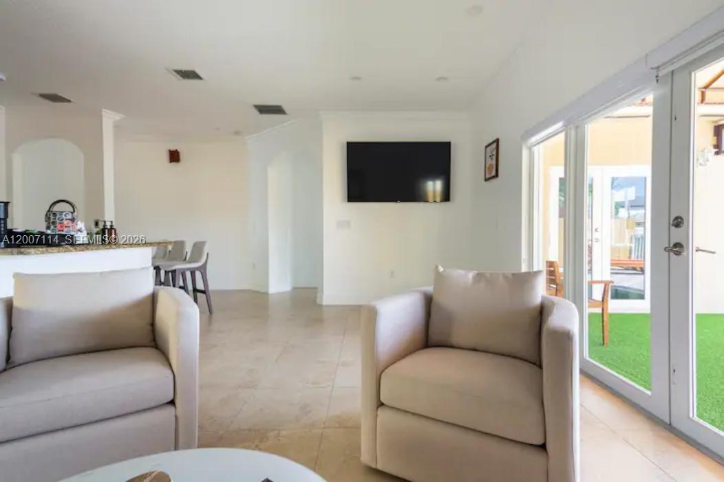 15566 Southwest 13th Terrace Miami, FL 33194 - Photo 9 of 27 a living room with furniture and a flat screen tv