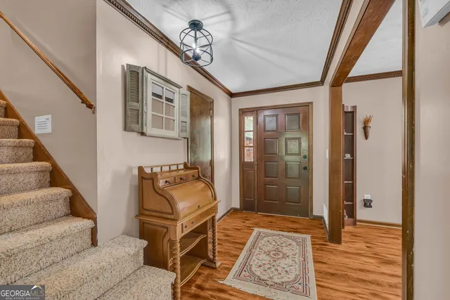 a living room with furniture a clock on wall and a window