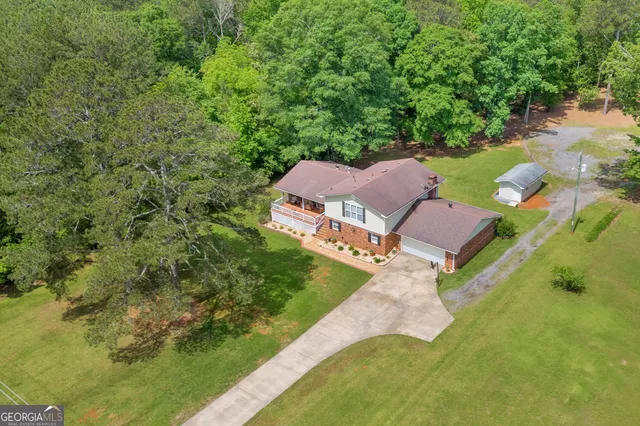 an aerial view of a house with yard swimming pool and outdoor seating