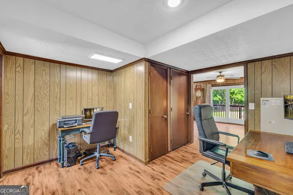 a spacious bedroom with a bed and a ceiling fan