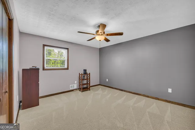 an aerial view of a house with swimming pool patio and lake view