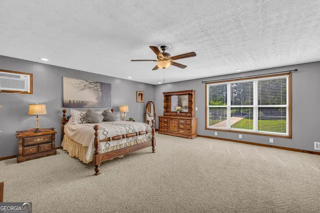 a front view of a house with a garden and trees