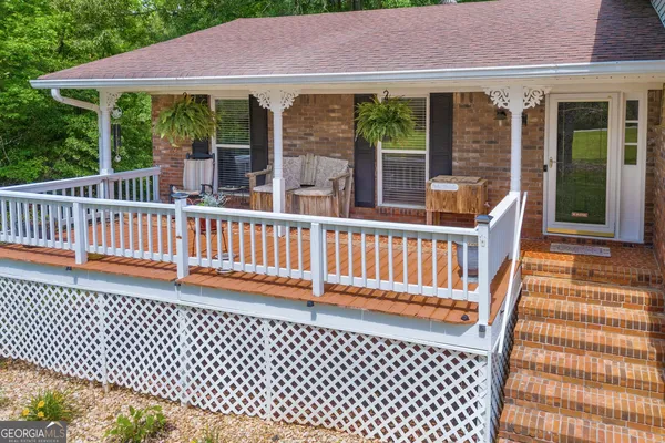 a view of balcony with potted plants and wooden fence
