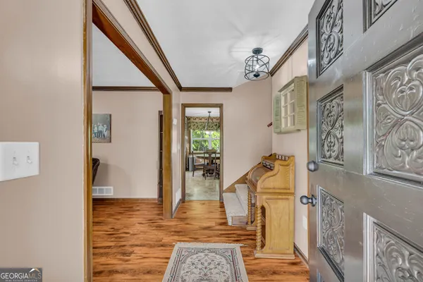 a living room with furniture and wooden floor